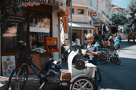 man standing near adult trike in front of store thumbnail