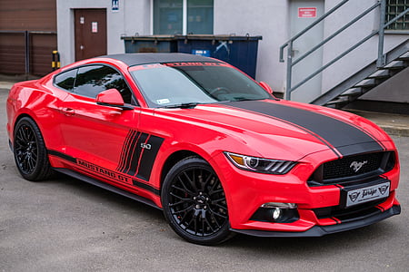 red and black Ford Mustang GT 5.0 coupe parked near gray building thumbnail
