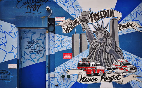 Statue of Liberty painted wall near door during daytime thumbnail