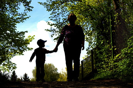 woman holding hand of boy thumbnail