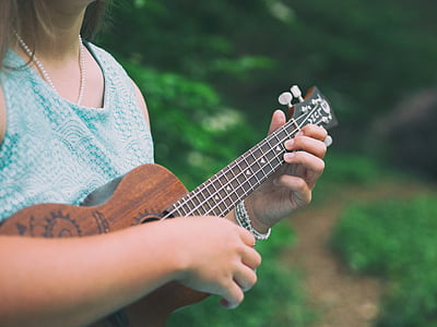 woman playing ukulele outdoors thumbnail