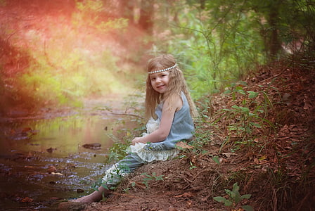 girl sitting on soil near body of water thumbnail