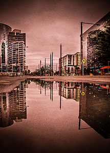 grayscale photo of water on road near buildings thumbnail