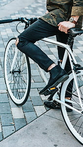 man riding bike wearing chelsea boots thumbnail
