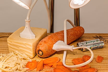 carrot plugged in by white coated wire beside two 3A Energizer batteries thumbnail