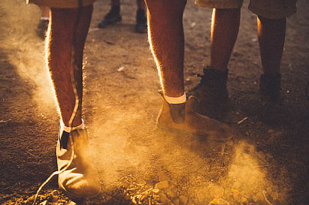 people wearing boots standing on brown soil during daytime thumbnail