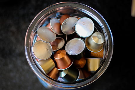 closeup photography of copper coffee flavor cans inside clear glass jars thumbnail