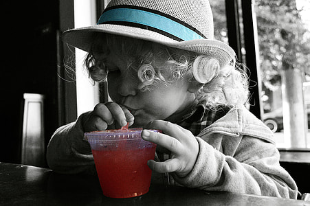 girl drinking beverage on cup greyscale photography thumbnail