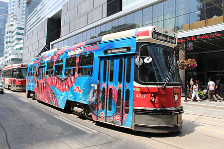 red and blue bus on road during daytime thumbnail