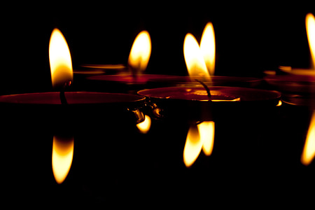 5 red candles lighted in the dark thumbnail