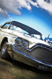 classic white car on green grass field thumbnail