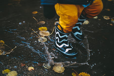 toddler wearing white-and-black rain boots thumbnail