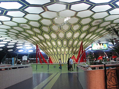 three people standing near rail guard in building thumbnail