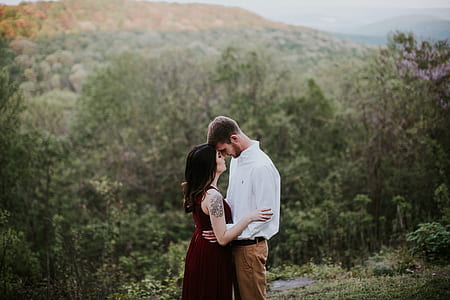 man and woman standing on grass thumbnail