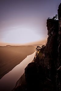 mountain near body of water under blue sky thumbnail