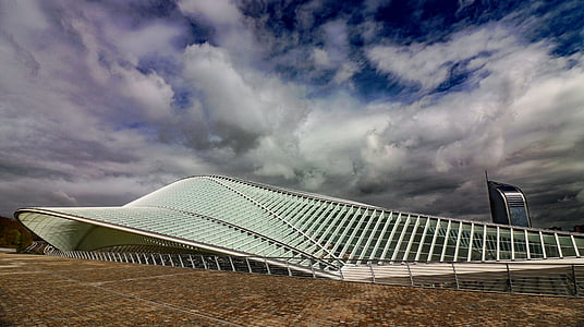 white and clear glass building under white and blue cloudy sky during daytime thumbnail