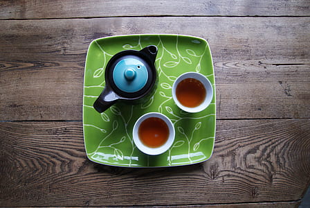 black ceramic kettle and two white coffee mugs thumbnail