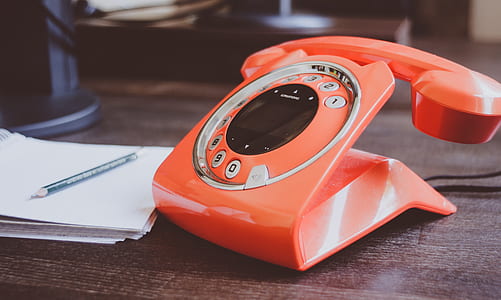 orange rotary telephone near the paper thumbnail