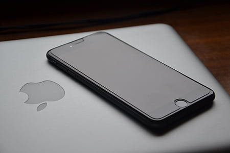 black iPhone 7 and MacBook thumbnail