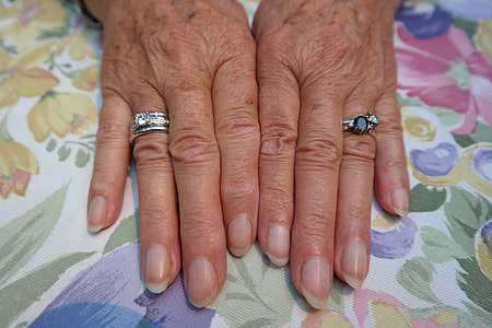 woman wearing two silver-colored rings thumbnail
