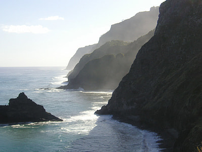 body of water near rock formations thumbnail