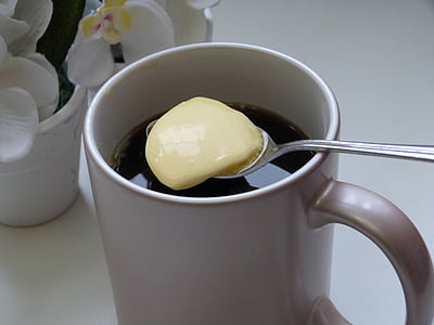 cup with black liquid inside and spoon on top thumbnail