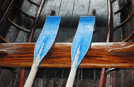 blue paddle on black boat thumbnail