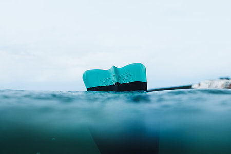 unpaired blue flipper in sea under clear blue sky during daytime thumbnail