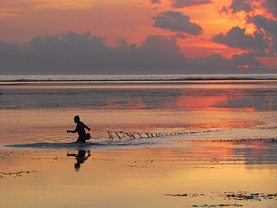 photo of person in body of water holding fishnet thumbnail