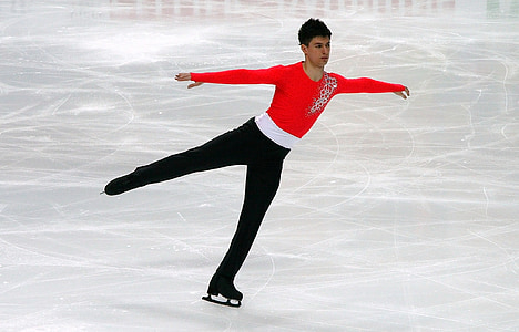 man in red and black suit ice skating thumbnail