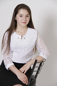 woman sitting on chair while taking photo thumbnail