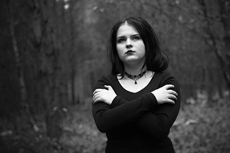 woman hugging her self in forest photo thumbnail