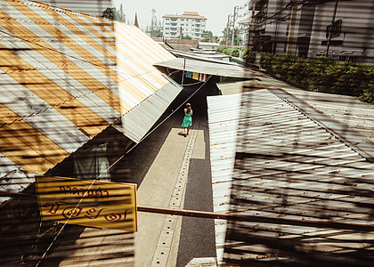 woman walking beside building thumbnail