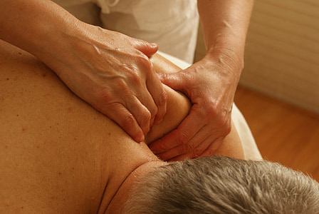 person standing beside lying man massaging his back thumbnail