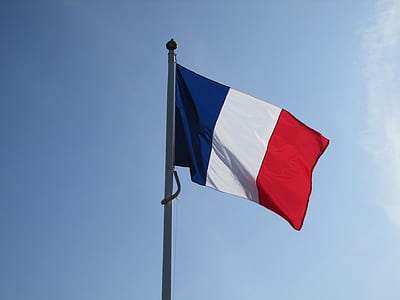 blue, white, and red flag on pole during daytime thumbnail
