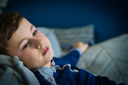 boy lying on grey textile thumbnail