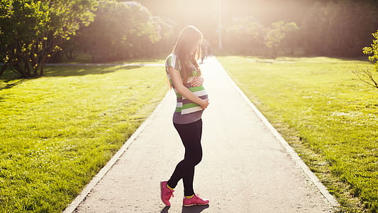 pregnant woman holding her stomach thumbnail