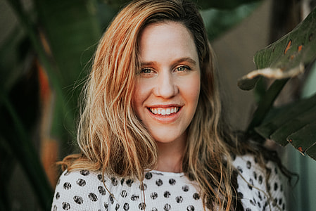 woman in white and black top showing her smile during daytime thumbnail