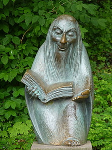 person reading book gray statue thumbnail