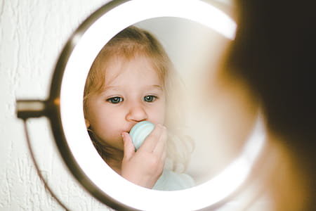 Toddler in Front of Round Stainless Steel Led Vanity Mirror thumbnail