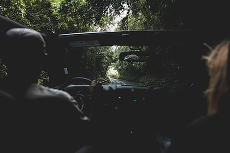 two persons riding on convertible vehicle on road thumbnail