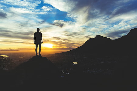 silhouette of man on top of mountain thumbnail