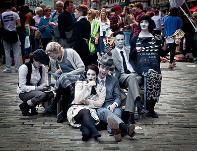 several people sitting on ground at daytime thumbnail