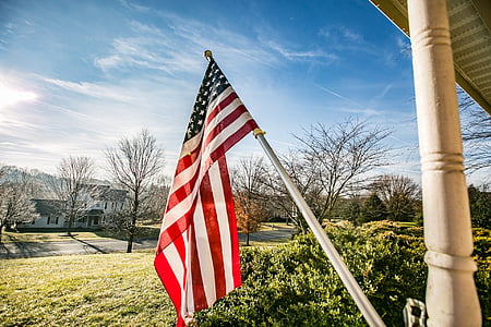 U.S.A. Flag near tall trees at daytime thumbnail