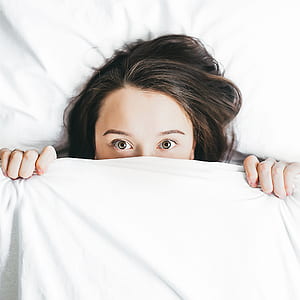 woman covering in white blanket thumbnail