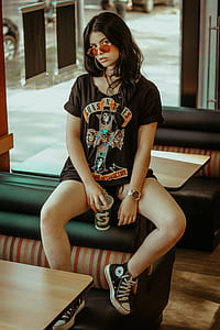 woman sitting on black leather couch thumbnail