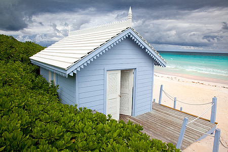 blue wooden house near ocean water thumbnail