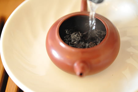 water poured in brown teapot thumbnail