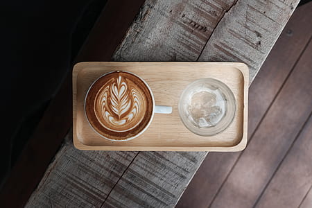 top view photography of ceramic mug filled with coffee latte thumbnail
