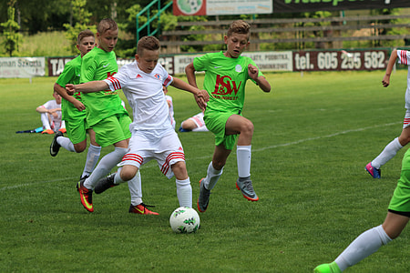 boy's playing soccer during daytime thumbnail
